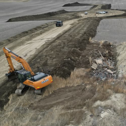 Excavator preparing the base of a road